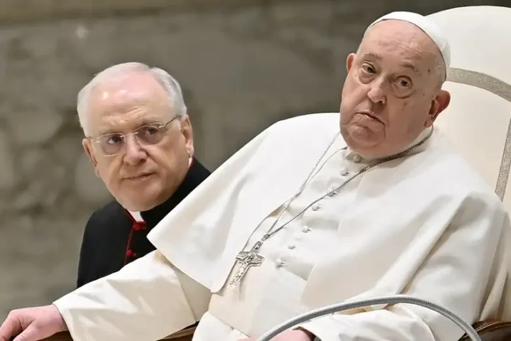 a man in a white robe sitting next to a man in a black robe